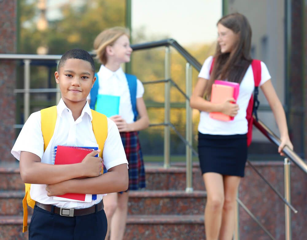 middle school preteens in school uniforms with backpacks