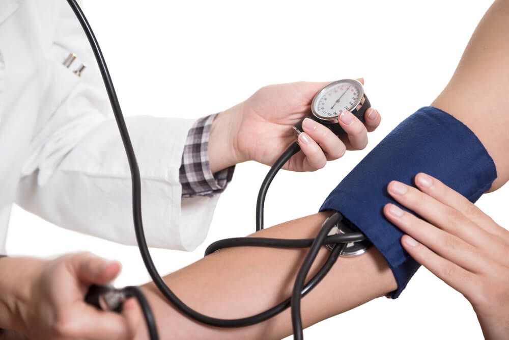 Doctor checks blood pressure during physical